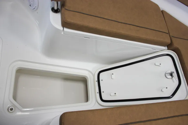 Slide: The Image of 2022 Sea Hunt Gamefish 25 boat interior with storage compartment and cushioned seating. - 55