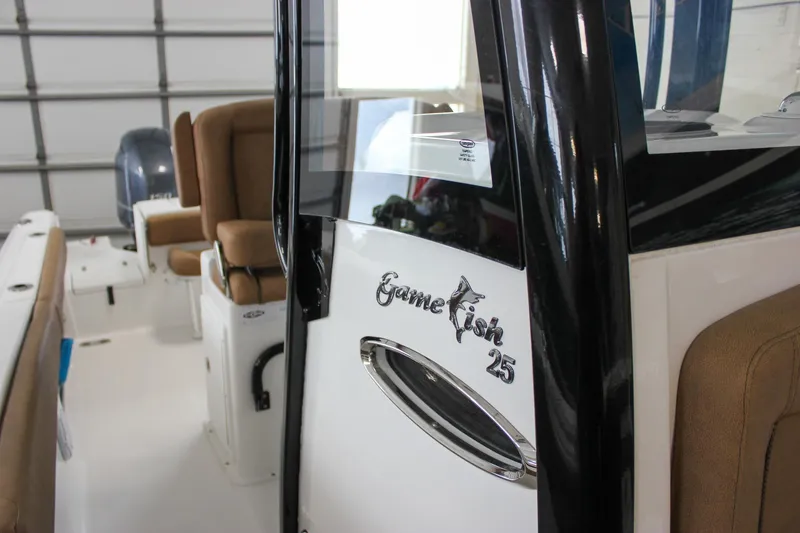 Slide: The Image of 2022 Sea Hunt Gamefish 25 boat interior with brown seating and sleek design. - 56