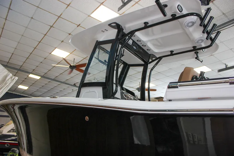Slide: The Image of 2022 Sea Hunt Gamefish 25 boat in showroom, featuring sleek design and modern equipment. - 58