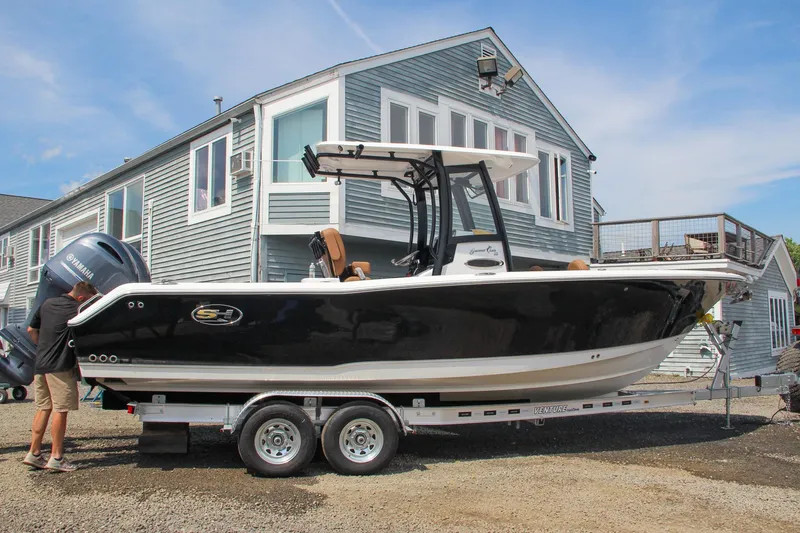 Slide: The Image of 2022 Sea Hunt Gamefish 25 boat on trailer, parked near a house. - 60