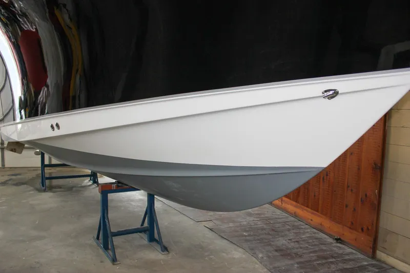 Slide: The Image of 2022 Sea Hunt Gamefish 25 boat hull on stands in a garage. - 63