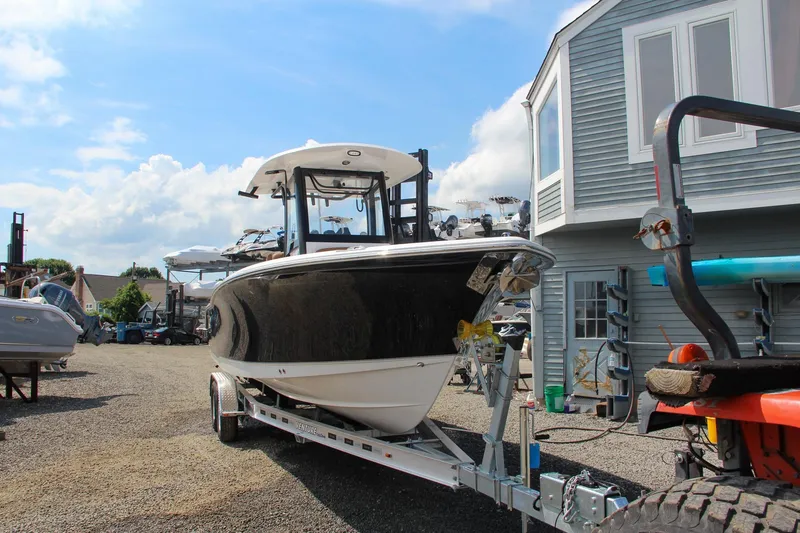 Slide: The Image of 2022 Sea Hunt Gamefish 25 boat on trailer, parked outdoors near a building. - 7