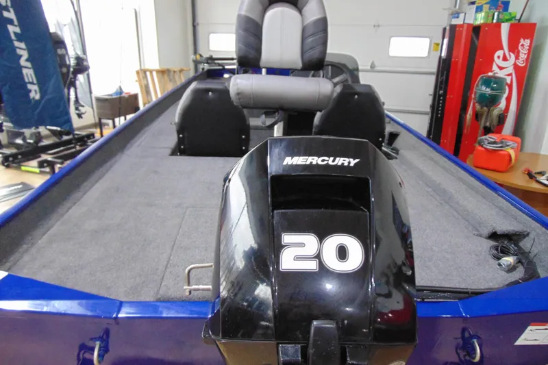 Slide: The Image of 2026 Crestliner 1700 Storm boat with Mercury 20 engine in a garage setting. - 11