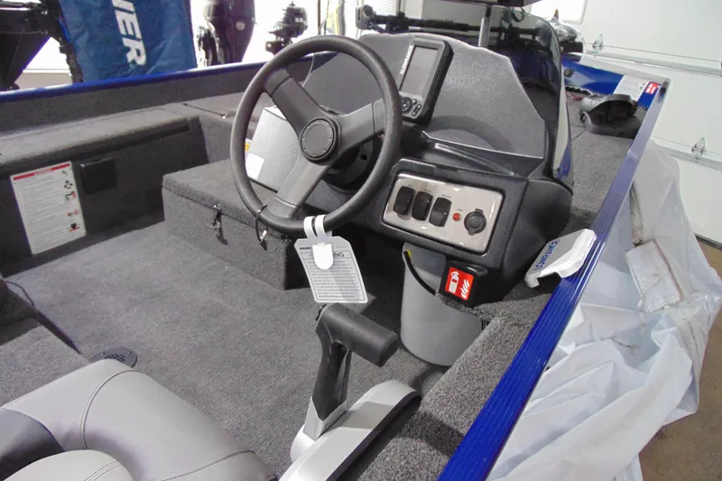 Slide: The Image of 2026 Crestliner 1700 Storm boat interior with steering wheel and control panel. - 14