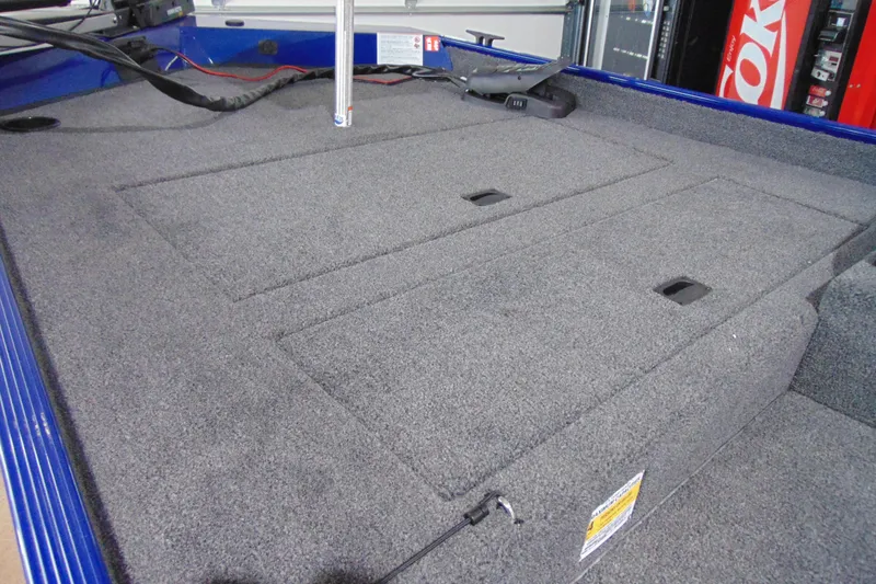 Slide: The Image of 2026 Crestliner 1700 Storm boat interior with carpeted deck and storage compartments. - 4