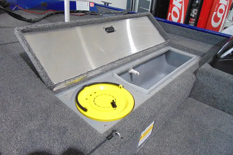 Slide: The Image of Open storage compartment in 2026 Crestliner 1700 Storm boat, featuring a yellow lid. - 5