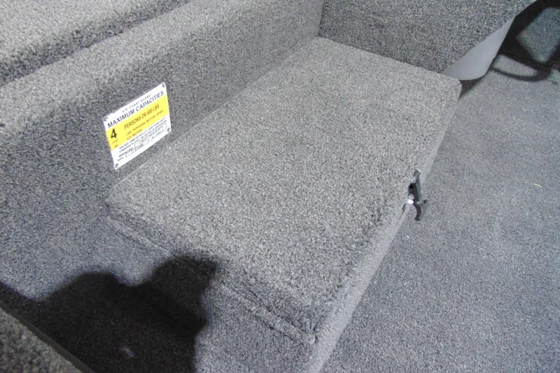 Slide: The Image of 2026 Crestliner 1700 Storm boat interior with carpeted seating and capacity label. - 6