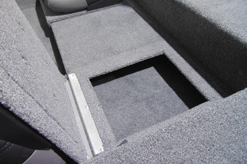 Slide: The Image of Carpeted storage compartment in 2026 Crestliner 1700 Storm boat interior. - 9
