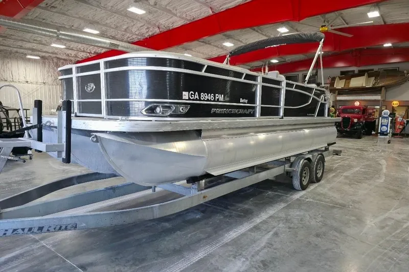 The Image of 2023 Princecraft Vectra 23 pontoon boat on trailer in indoor showroom. - 1