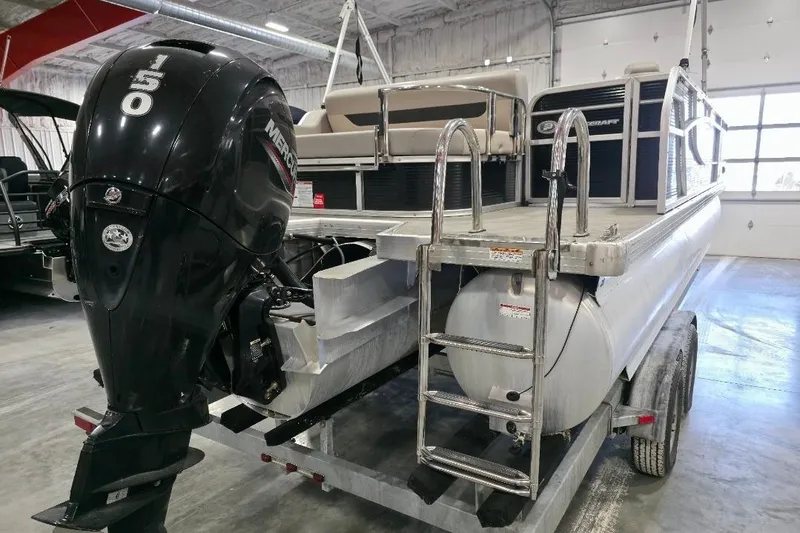 Slide: The Image of 2023 Princecraft Vectra 23 pontoon boat with Mercury outboard motor in a showroom. - 5