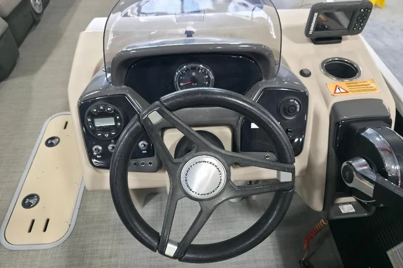 Slide: The Image of 2023 Princecraft Vectra 23 boat dashboard with steering wheel and control panel. - 9