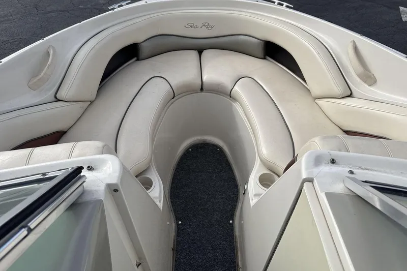 Slide: The Image of 2004 Sea Ray 220 Select boat interior with white cushioned seating. - 11