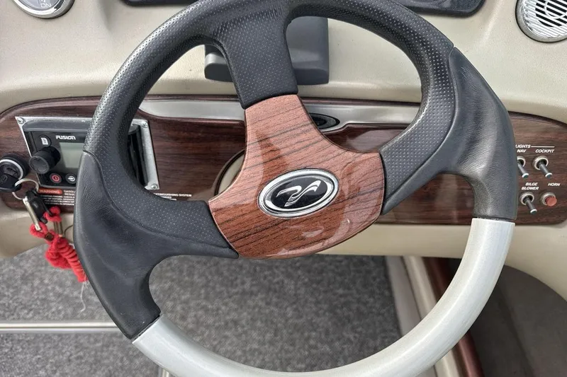 Slide: The Image of Steering wheel of 2004 Sea Ray 220 Select boat with wood and leather accents. - 14