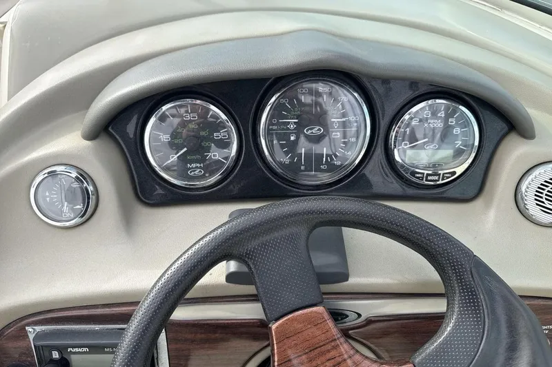 Slide: The Image of Dashboard of a 2004 Sea Ray 220 Select boat with gauges and steering wheel. - 15