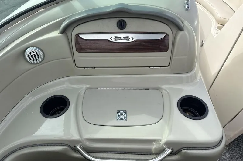 Slide: The Image of 2004 Sea Ray 220 Select boat interior with cup holders and storage compartment. - 18