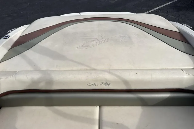 Slide: The Image of 2004 Sea Ray 220 Select boat interior with beige and brown upholstery. - 19