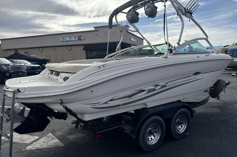 Slide: The Image of 2004 Sea Ray 220 Select boat on trailer, parked outdoors under cloudy sky. - 5
