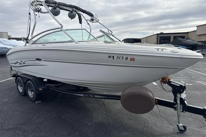 Slide: The Image of 2004 Sea Ray 220 Select boat on trailer in parking lot, overcast sky. - 7
