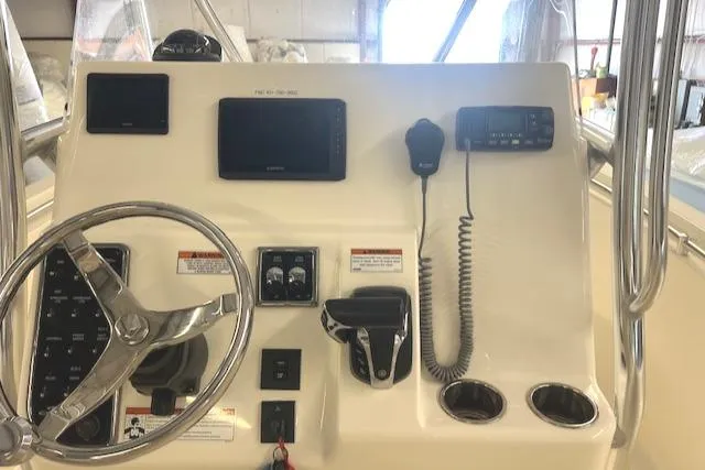 Slide: The Image of Cobia 237 Center Console 2022 helm with controls and displays. - 11