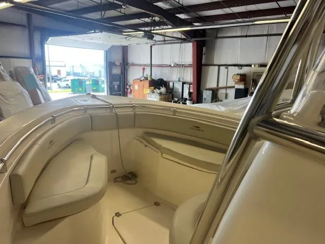 Slide: The Image of Interior view of a 2022 Cobia 237 Center Console boat in a warehouse. - 2