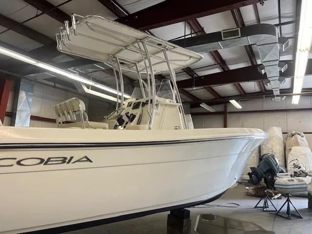 Slide: The Image of 2022 Cobia 237 Center Console boat in warehouse. - 9