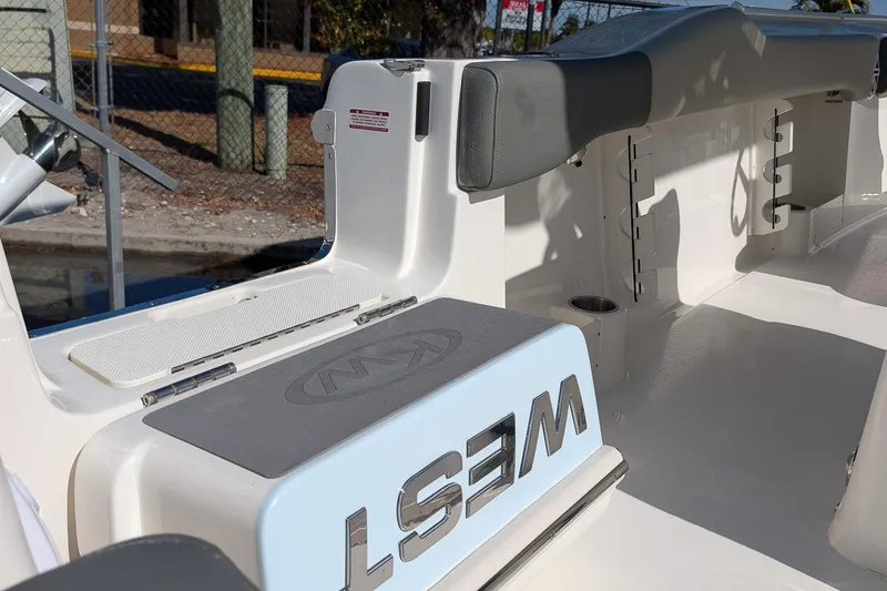 Slide: The Image of 2026 Key West 263 FS boat interior with seating and storage compartments. - 12