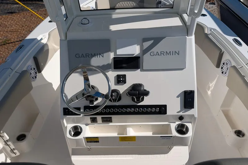 Slide: The Image of 2026 Key West 263 FS boat dashboard with Garmin navigation system and steering wheel. - 15