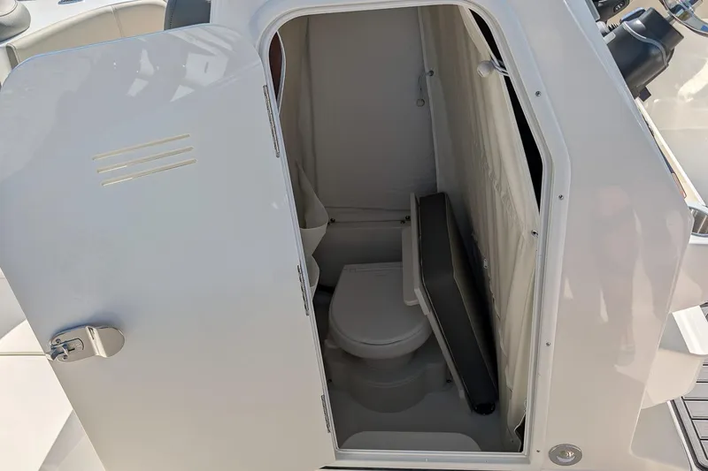 Slide: The Image of 2026 Key West 263 FS boat interior with compact marine toilet. - 16