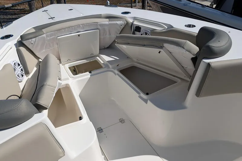 Slide: The Image of 2026 Key West 263 FS boat interior with open storage compartments and cushioned seating. - 19