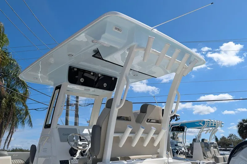 Slide: The Image of 2026 Key West 263 FS boat with T-top and rod holders under a clear blue sky. - 22