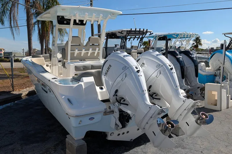 Slide: The Image of 2026 Key West 263 FS boat with dual Yamaha outboard engines, parked outdoors. - 3