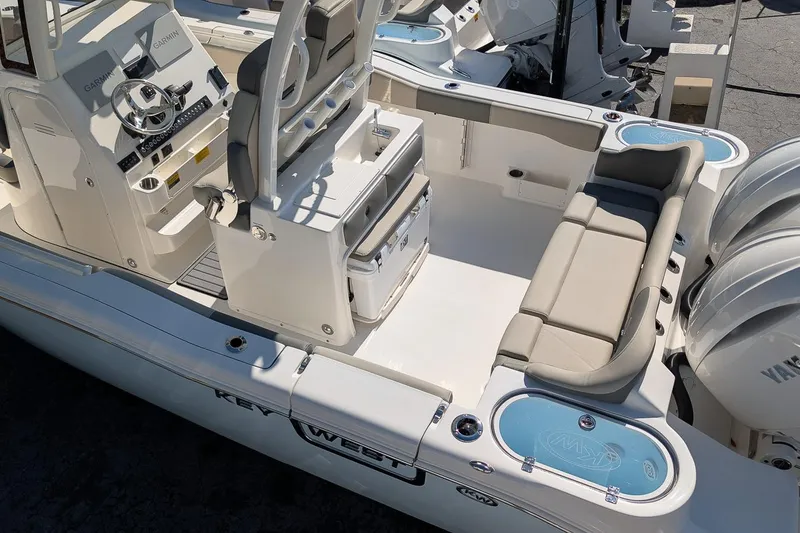 Slide: The Image of 2026 Key West 263 FS boat interior with seating and dual Yamaha engines. - 7