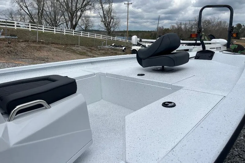 Slide: The Image of 2026 Xpress H20B Bay boat interior with seating, white deck, and overcast sky. - 4