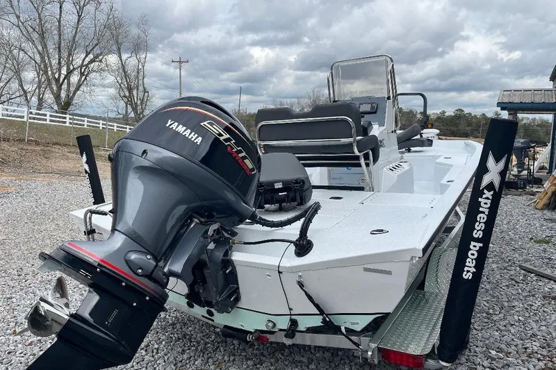 Slide: The Image of 2026 Xpress H20B Bay boat with Yamaha engine, parked on gravel. - 8