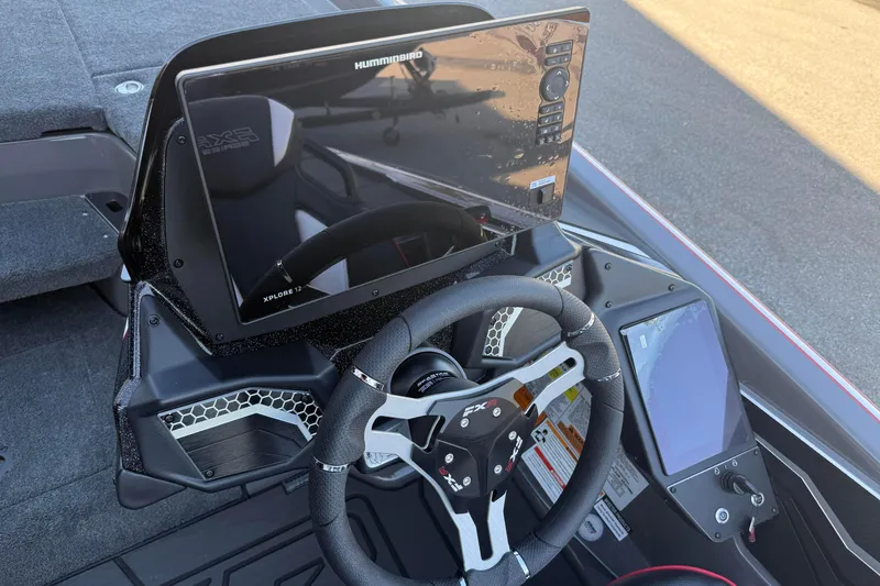 Slide: The Image of 2026 Skeeter FXR20 boat dashboard with Humminbird electronics and steering wheel. - 10