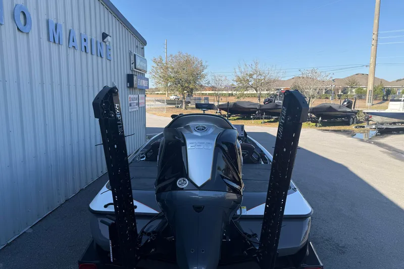 Slide: The Image of 2026 Skeeter FXR20 boat with powerful engine, parked outside a marine dealership. - 15