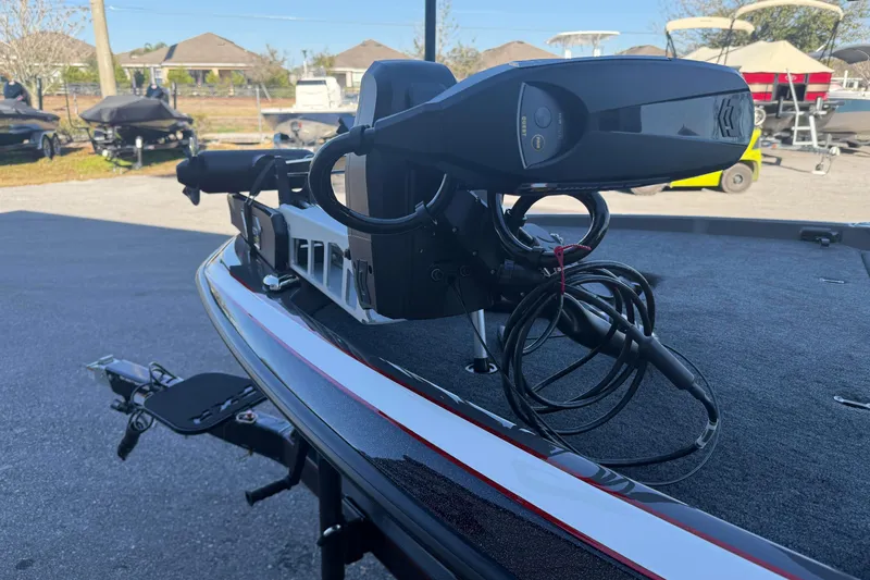 Slide: The Image of 2026 Skeeter FXR20 boat with advanced trolling motor, parked outdoors. - 2