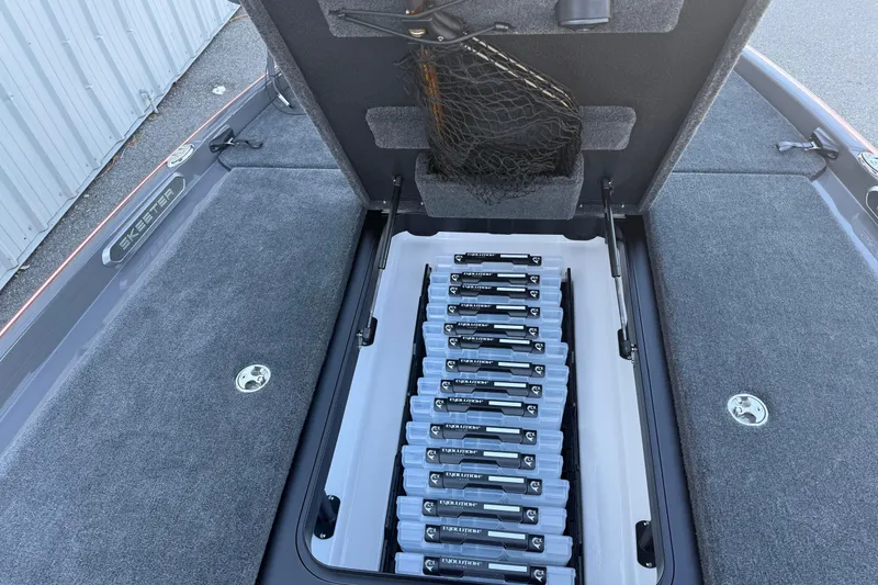 Slide: The Image of 2026 Skeeter FXR20 boat with organized tackle storage compartment open. - 7