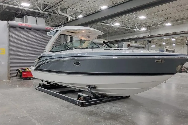 Slide: The Image of 2026 Formula 310 Bowrider I/O boat in a spacious indoor facility. - 1