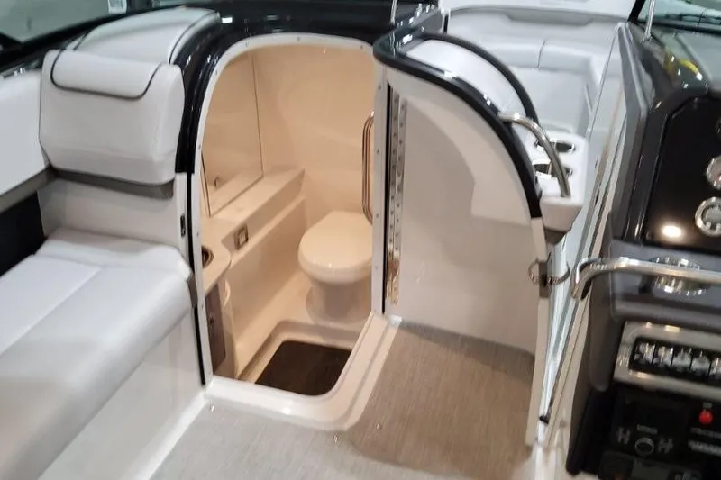 Slide: The Image of 2026 Formula 310 Bowrider I/O boat interior with open bathroom door. - 15