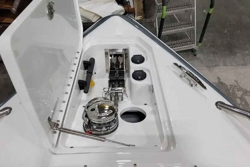 Slide: The Image of 2026 Formula 310 Bowrider I/O anchor compartment with winch and storage features. - 20