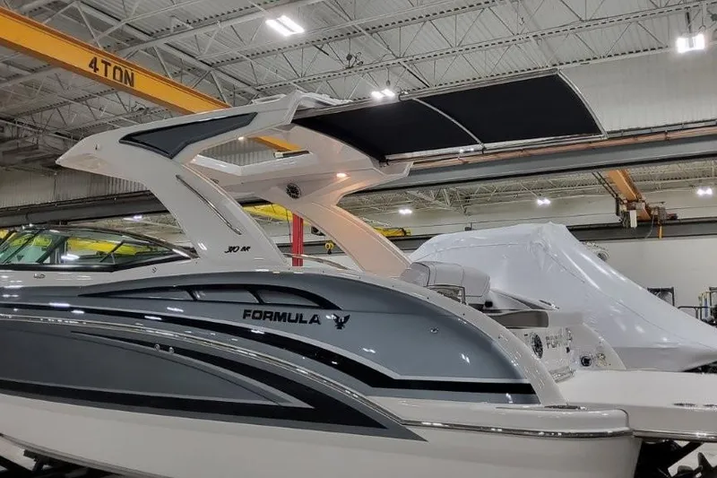 Slide: The Image of 2026 Formula 310 Bowrider I/O boat in a warehouse, showcasing sleek design and modern features. - 3