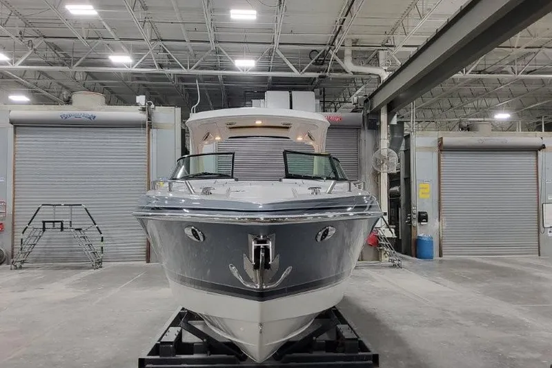 Slide: The Image of 2026 Formula 310 Bowrider I/O boat in a warehouse, front view. - 4