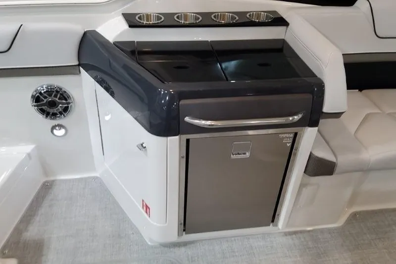 Slide: The Image of Interior of 2026 Formula 310 Bowrider I/O boat with sleek kitchenette and seating area. - 8