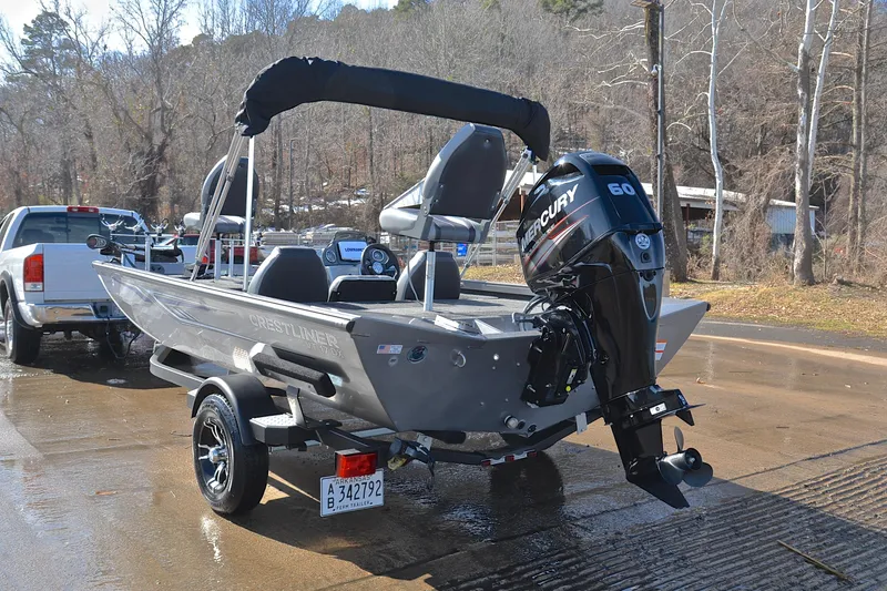 Slide: The Image of 2017 Crestliner VT 17 boat with Mercury 60 engine on trailer, parked near a truck. - 12