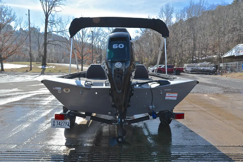 Slide: The Image of 2017 Crestliner VT 17 boat with 60 HP motor on a trailer in a scenic outdoor setting. - 13