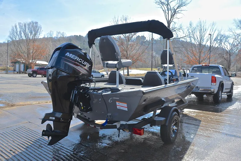 Slide: The Image of 2017 Crestliner VT 17 boat with Mercury engine on trailer, parked near a pickup truck. - 14