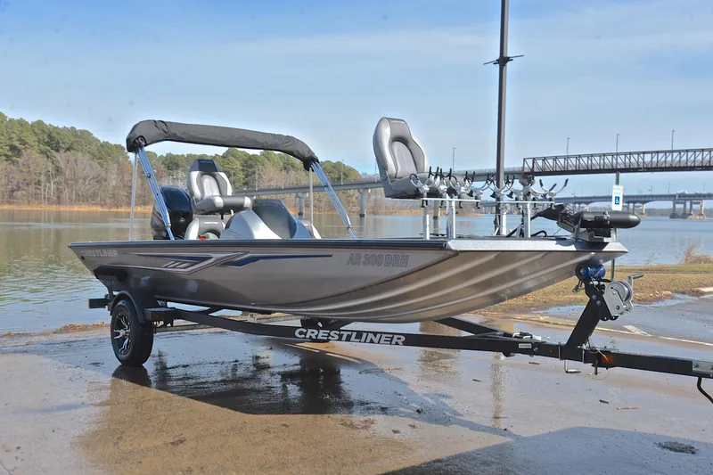 Slide: The Image of 2017 Crestliner VT 17 fishing boat on trailer by a lake with bridge in background. - 16