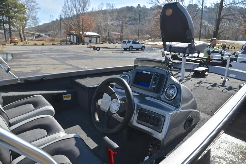 Slide: The Image of 2017 Crestliner VT 17 boat interior with steering wheel and dashboard in a parking area. - 19