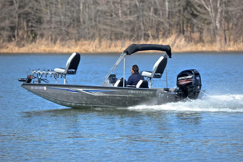 Slide: The Image of 2017 Crestliner VT 17 boat cruising on a lake with Mercury outboard motor. - 4